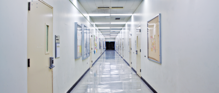 Brightly lit school hallway with doors