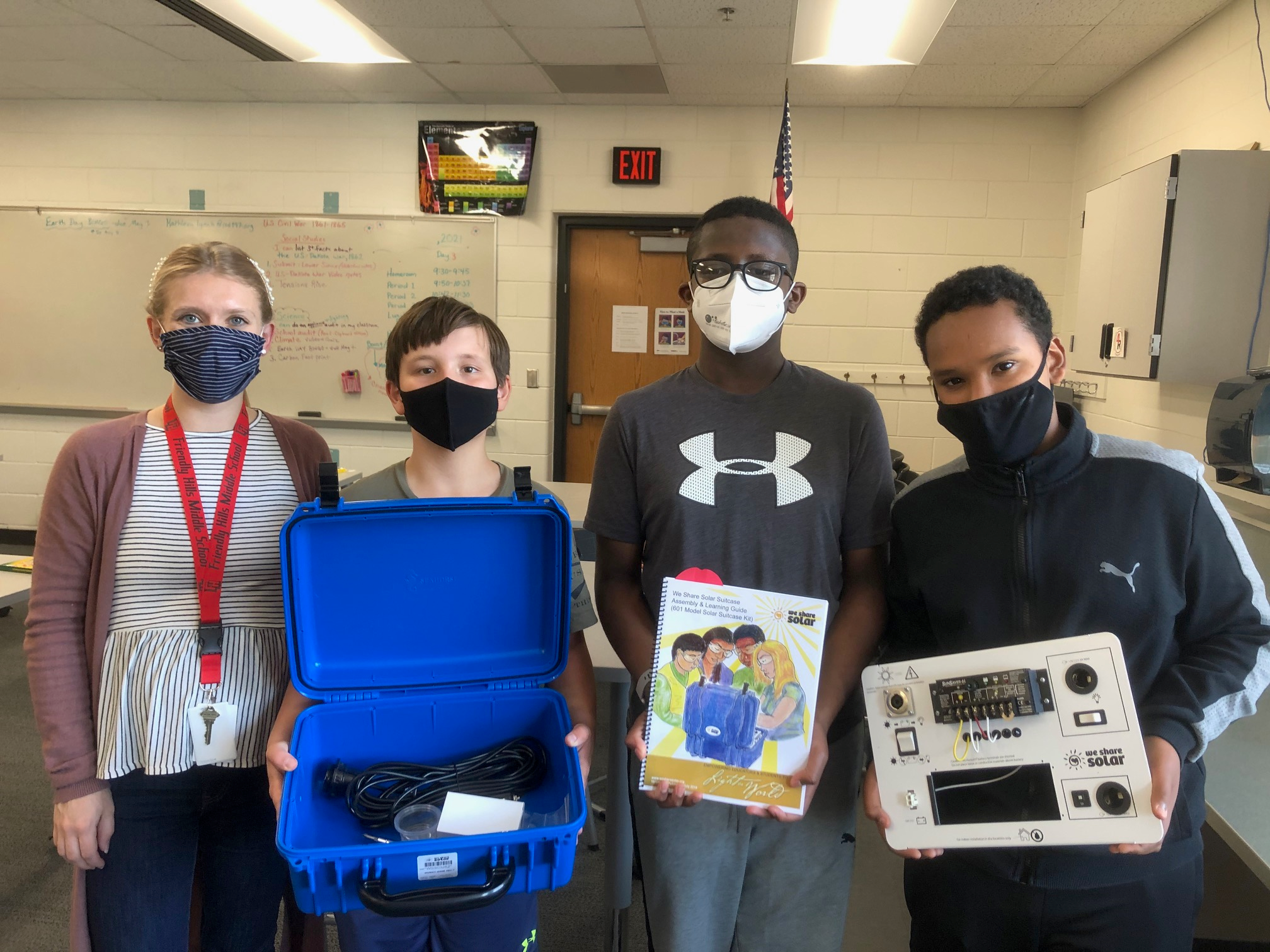 4 students from ISD 197 holding equipment